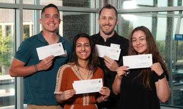 Students holding checks